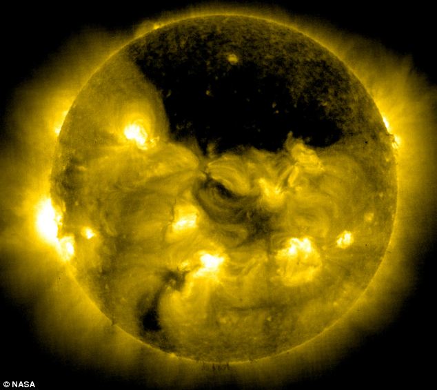 A 'gigantic hole' in the sun's atmosphere, hovering over the solar north pole has been photographed by a space telescope